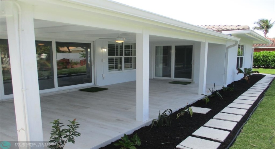 Covered Patio with Stepping Stones around to the front of the house on the north side.