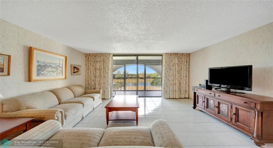 Spacious Living Room with Patio Doors to Screened Balcony
