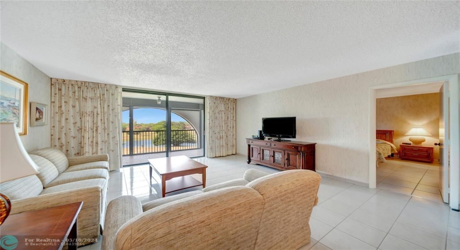 Living Room; Patio Doors To Screened Balcony; Doorway to Master Bedroom on Right