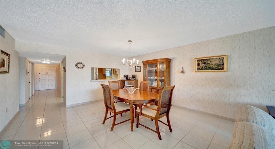 Dining Room with Pass-Through to Kitchen; Front Door Entrance and Hallway