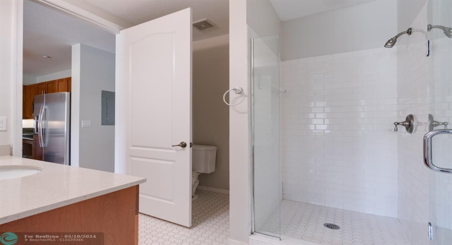Large Bathroom with spacious Walk-in shower with two entry accesses 1, from Kitchen/family room and one from the Master Bedroom