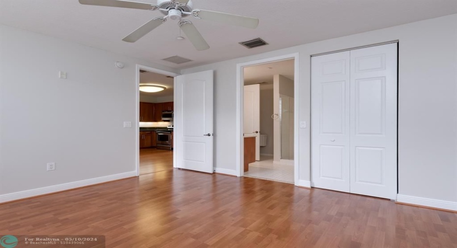 Large walk-in closet next to entrance to bathroom