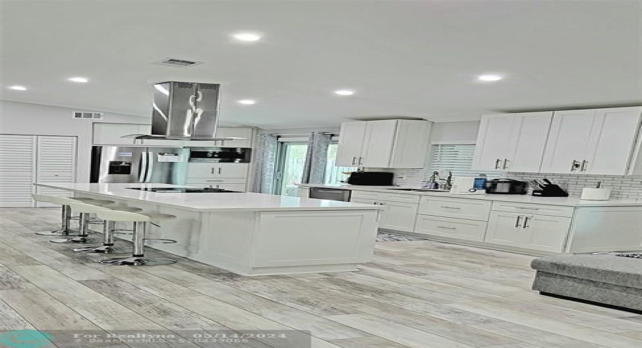 A white kitchen and pleny of lighting