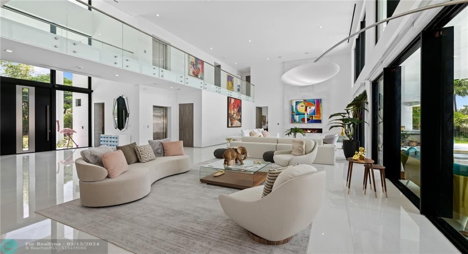 GRAND LIVING ROOM WITH SOARING CEILING AND NATURAL LIGHT