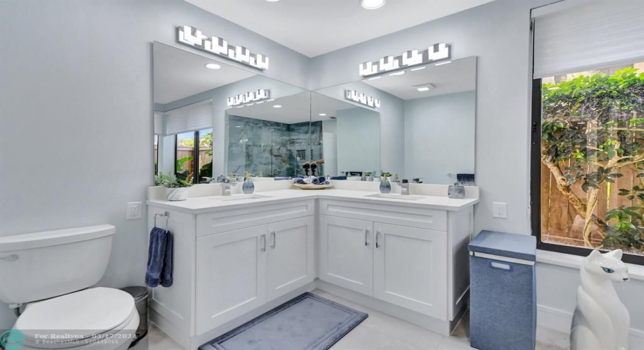 Primary bathroom features double corner vanity w/LED light fixtures
