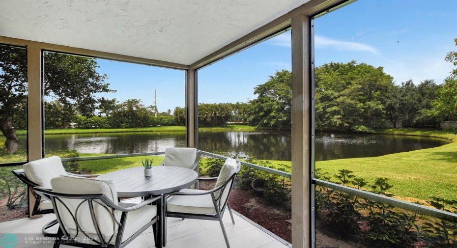 Spacious outdoor dining on screen enclosed patio.