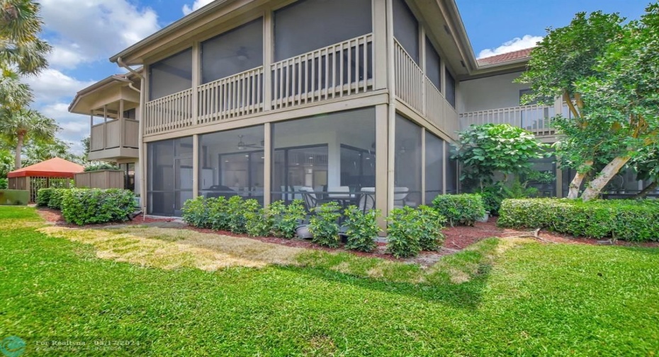 Wrap around screened patio and privacy fence at bedroom windows provide a sense of single family living.