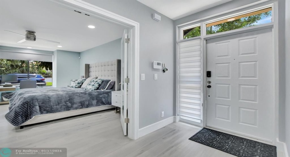 Front foyer opens to French doors leading to Primary Bedroom