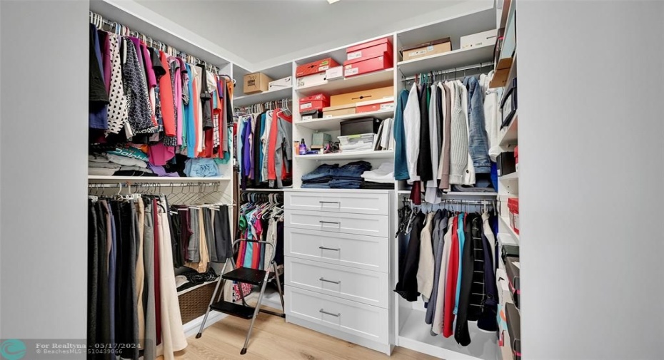 Primary Bedroom closet with custom built ins