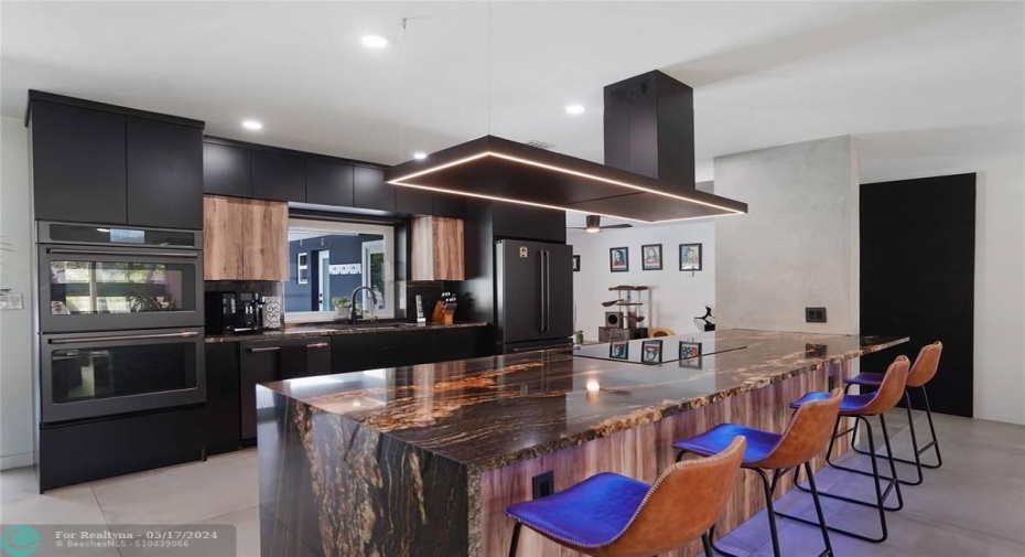 The stove top is convection. That lit stove hood is stunning. The double ovens have smart stove features and double as air fryers.
