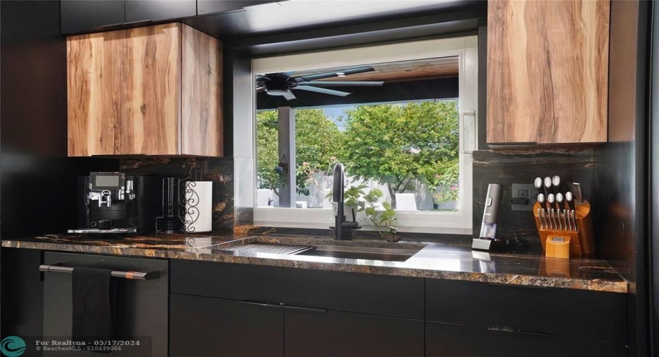 The window looks out onto the private and beautifully landscaped back yard and pool.
