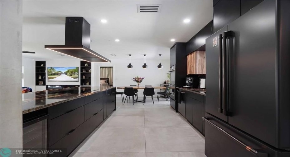 Facing into the dining area. Note the wine refrigerator under the granite counter top.