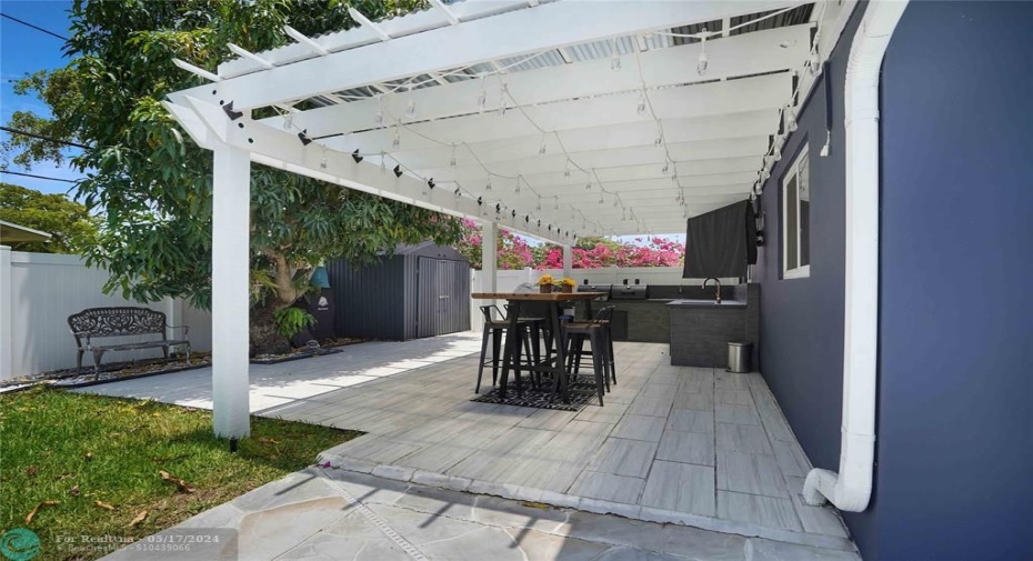 A lovely yard surprise; a full kitchen and tv is around the corner.
