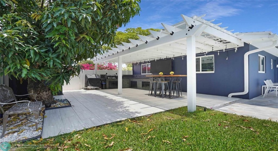 This yard has 4 plumeria trees, 2 mango trees, a coconut tree, a lime and avocado tree, a lemon tree and an herb garden.