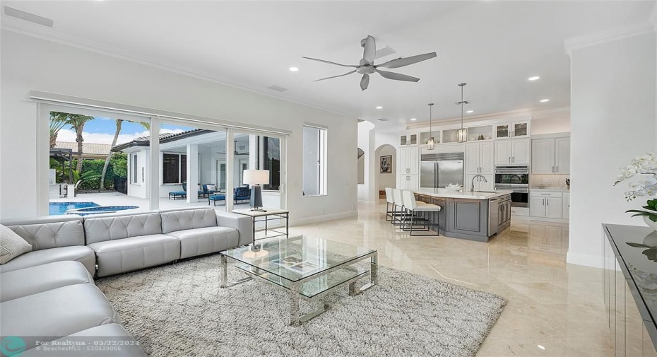 Extended family room with lots of large windows of sunshine, The Hurricane impact sliding glass doors slide all the way back to open up the patio to the family room & kitchen
