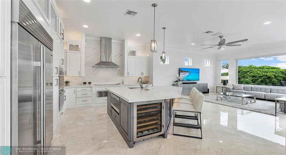 The 2 tone Kitchen view as you enter into the kitchen and family room with pendant lighting & center island, Quartz Counter tops
