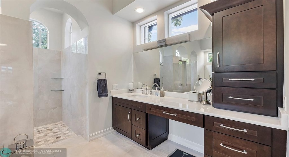 Vanities on each side of the bathroom for spacious healthcare,Cherry wood cabinets with brushed nickel hardware