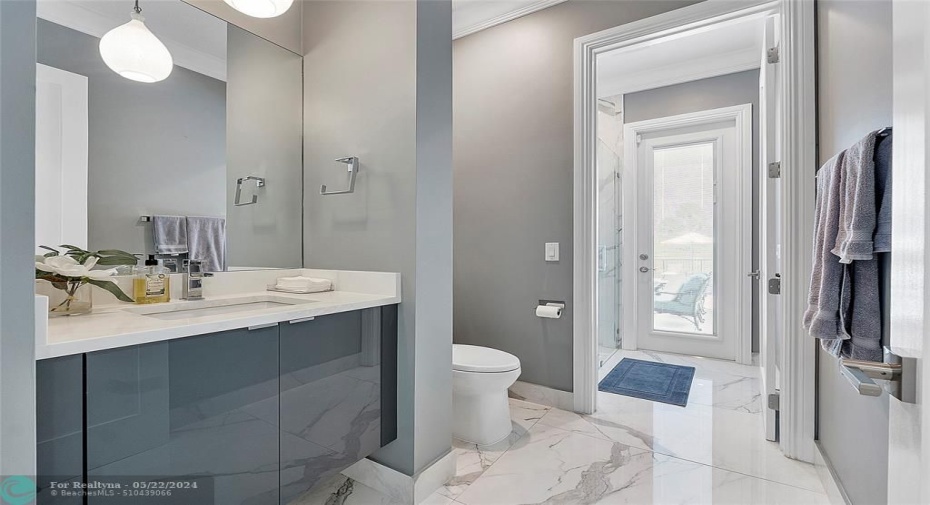 Full Cabana bathroom for with Porcelain flooring for poolside BBQ  & entertainment & guests with walk in modern shower, vanities & pendant lighting,