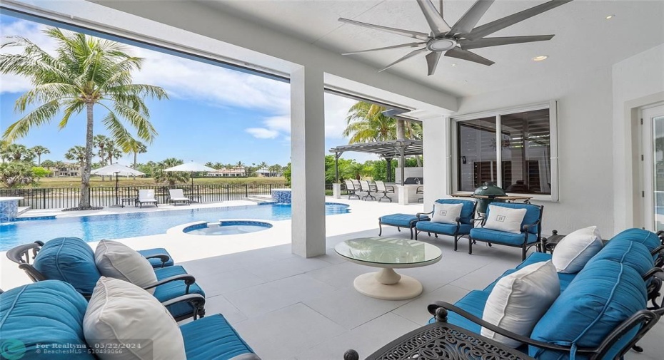 Daytime view from the Patio, looking out onto the pool, lake and palm trees