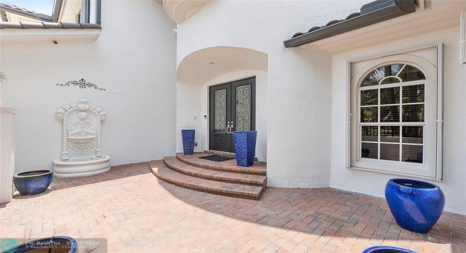 Courtyard entryway with tranquil waterfall, Double oak European entry doors