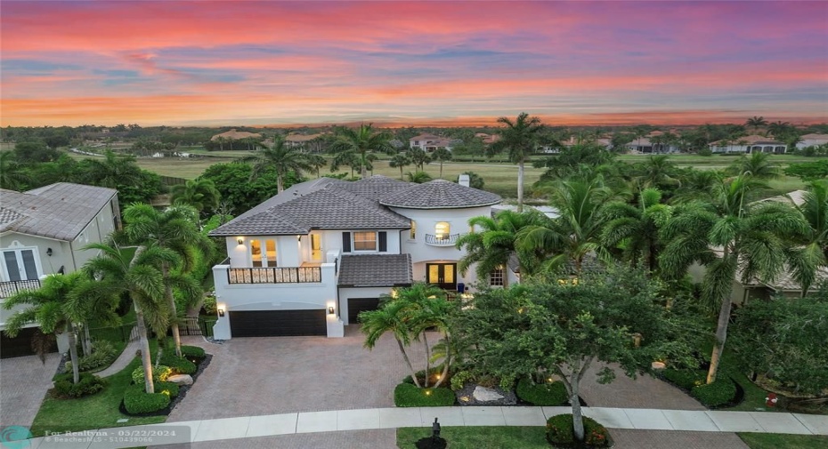 Aerial sunset view of the home at sunset, No neighbors behind ever! Circukar driveway that can fit at least 8 cars