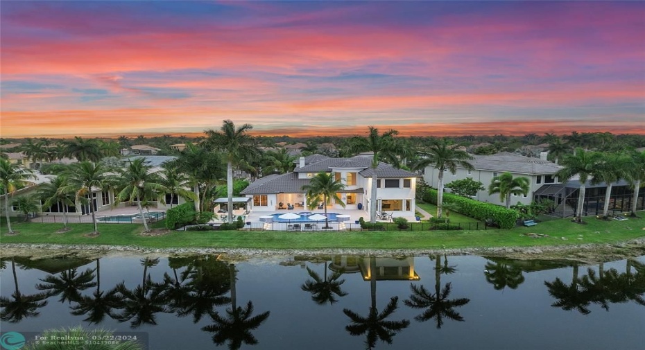 Capture this image from across the lake, This home has been remodeled to perfection with everything and a brand new roof (Tobacco color) Pergula, Summer kitchen and sapphire blue pool that was remodeled in 2021 with a new pool deck, Who is coming over for a BBQ?