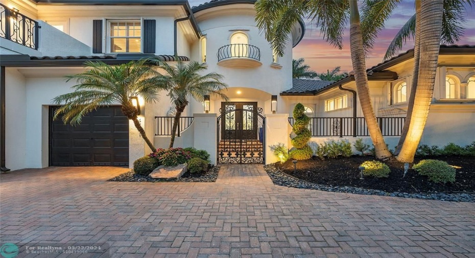The Castle tower entryway with lit lush landscaping