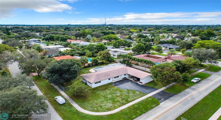One of the largest lots in the neighborhood with exotic fruit trees and fenced yard