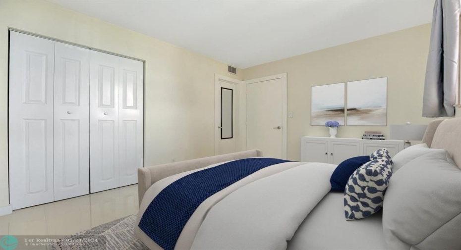Generous guest bedroom with a wall closet & raised panel doors.