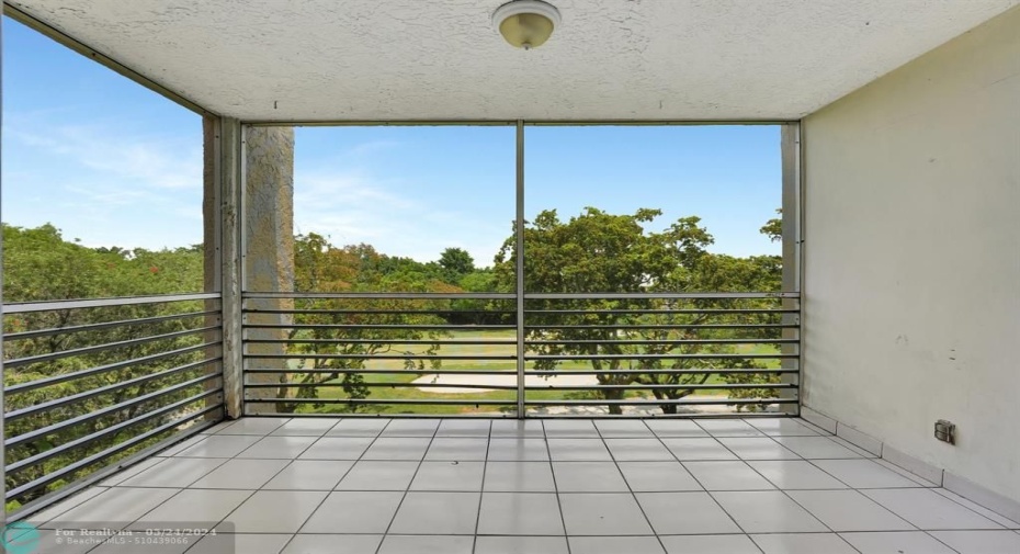 Screened balcony with golf and preserve views.