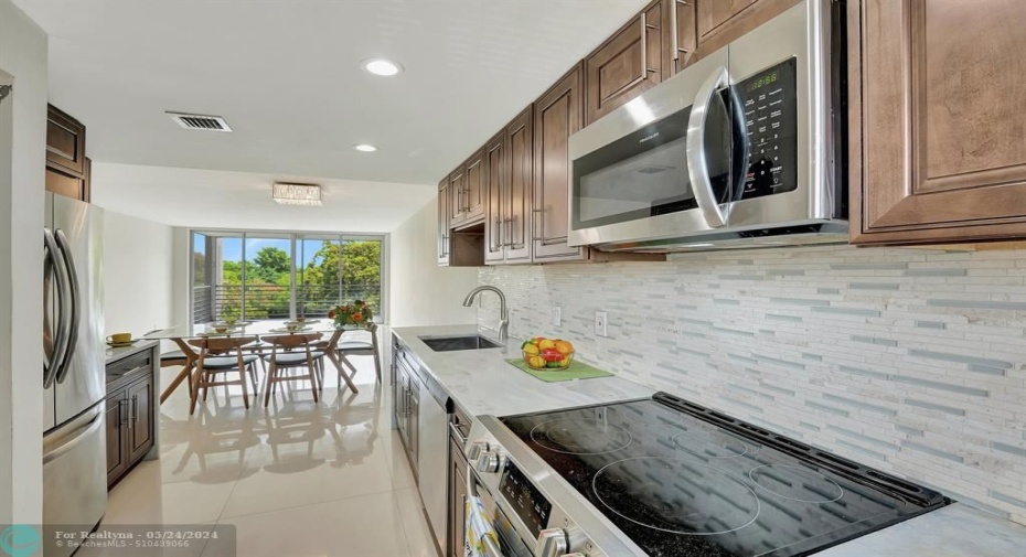 Fabulous kitchen  counters and full backsplash boasting glass and tumbled marble.