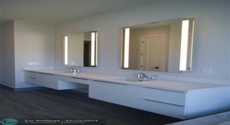 Master Bath Cabinetry with Back lit mirrors from previously built Deerwood