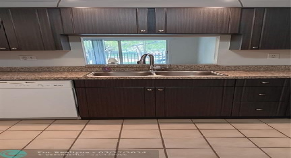From kitchen look out to living area & balcony